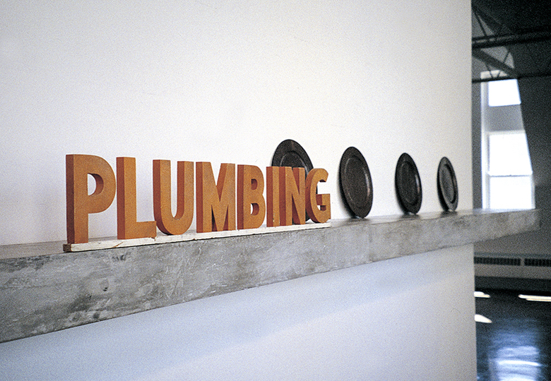 PLUMBING sign